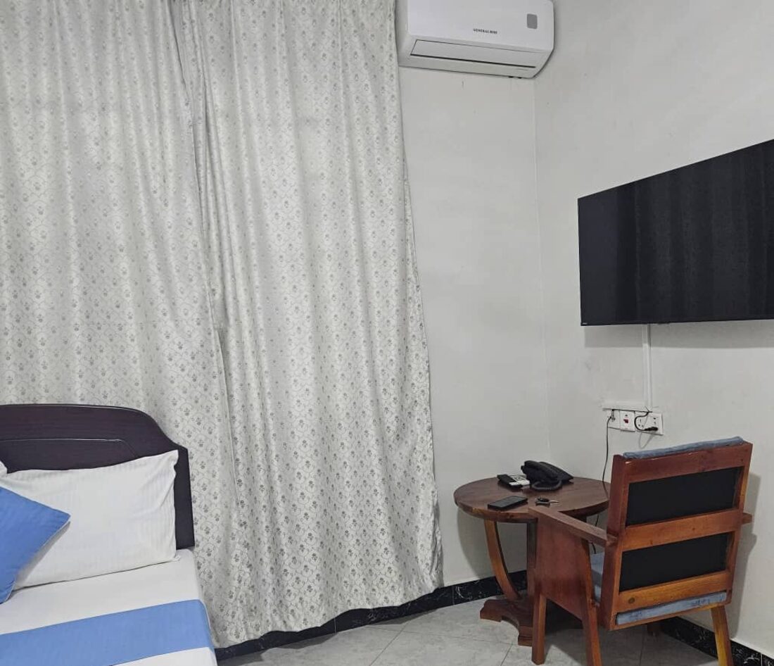 Rweru Hotel room with air conditioning, a flat-screen TV and a seating area